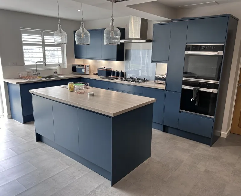Kitchen cabinets and island professionally sprayed in deep blue by Bespoke Finishings
